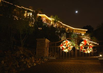 Two Lit and Decorated Gate Wreaths
